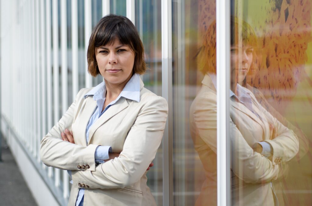 businesswoman suit standing front glass window with crossed arms